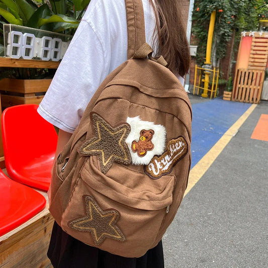 A stylish and durable canvas backpack with geometric patterns, designed for female college students