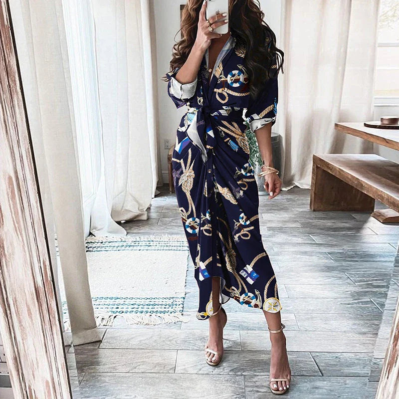 A beautiful floral wrap dress with lace-up detailing, featuring a deep V-neck and full-length skirt for a flattering, elegant look.