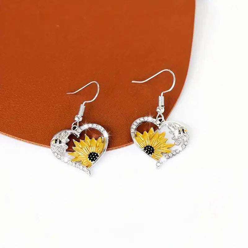 Elegant silver earrings featuring delicate bee and sunflower motifs, a stunning fashion accessory with natural charm.