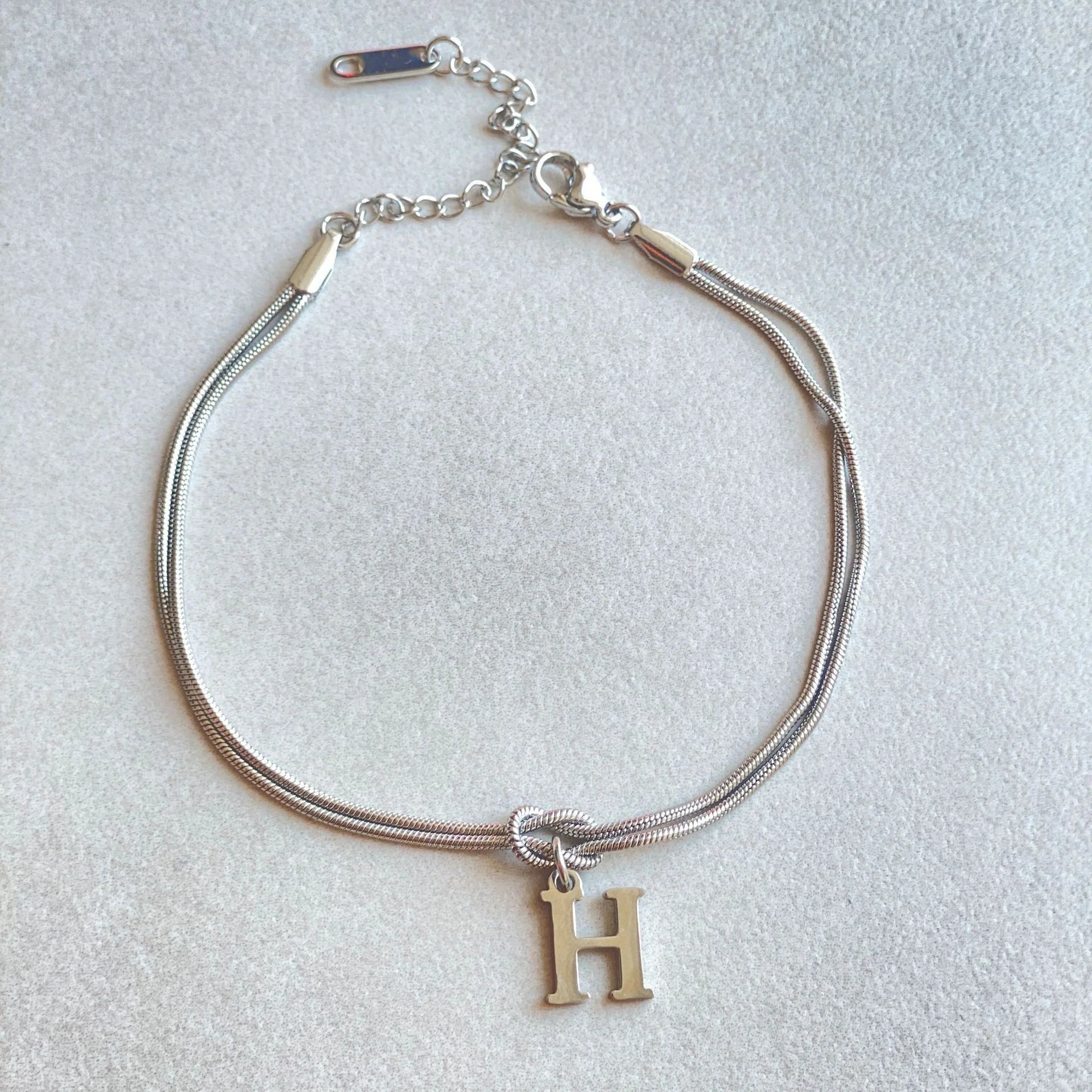 Personalised gold and silver love knot bracelets for couples, perfect as Valentine's Day gifts.