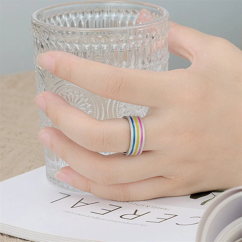 Iridescent titanium steel rings with rainbow-like oil treatment and sleek, flower-inspired design