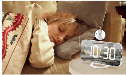 Digital mirror clock with LED display and dual USB ports on a desk