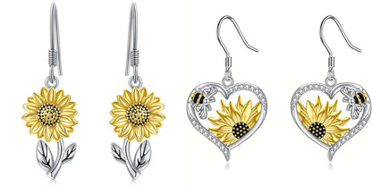 Elegant silver earrings featuring delicate bee and sunflower motifs, a stunning fashion accessory with natural charm.