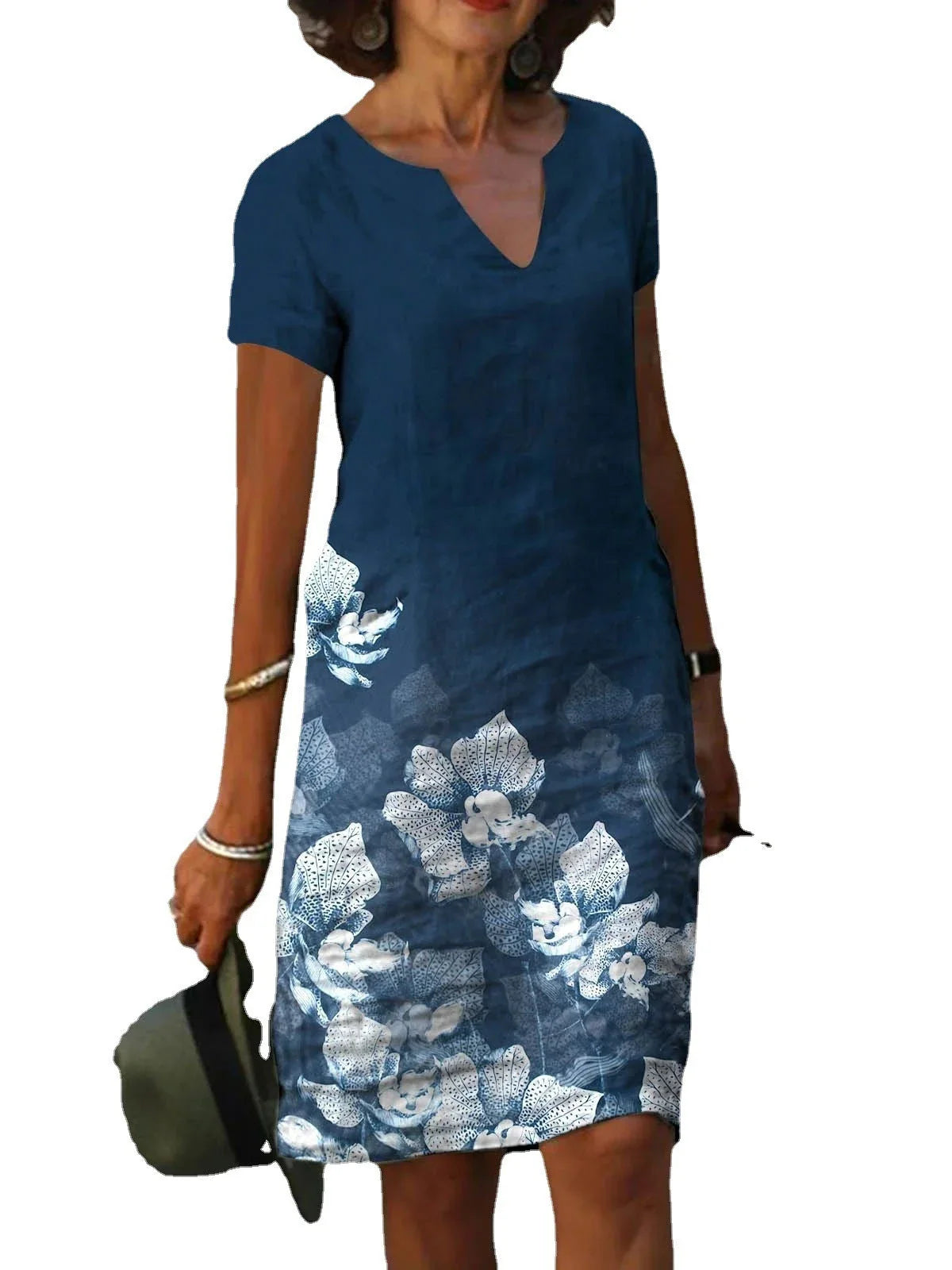 A floral printed midi dress made from a cotton-linen blend fabric, featuring a V-neck and short sleeves.