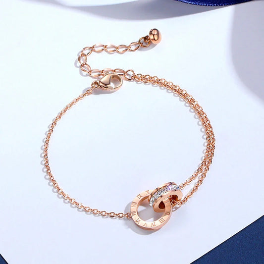 Rose gold titanium steel bracelet with zircon inlay and roman numeral detailing
