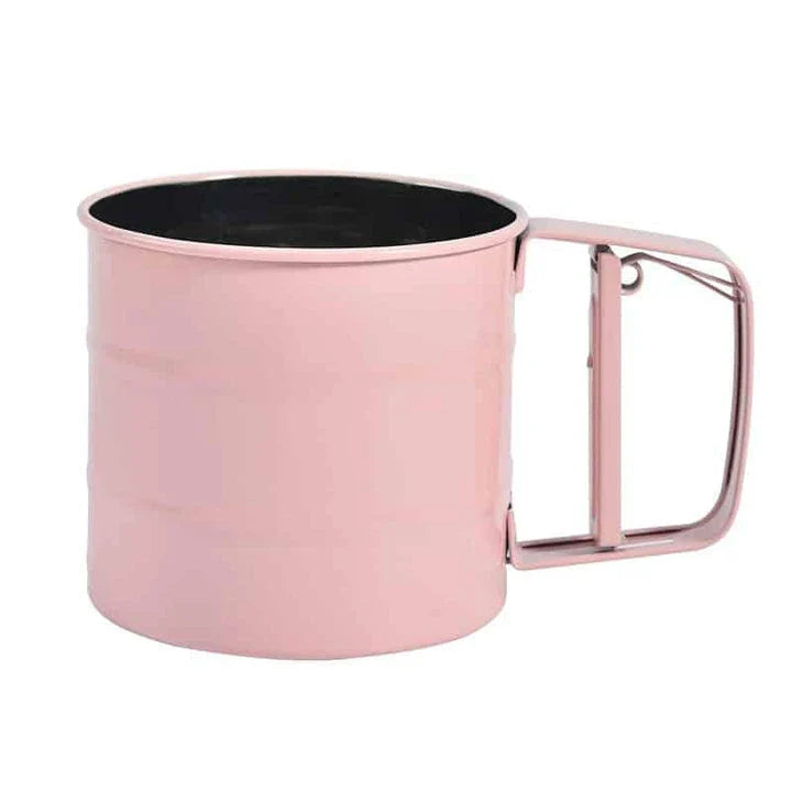 Stainless steel handheld baking flour sifter in a soft pink colour, designed for efficient sifting and aeration of dry ingredients for light and fluffy baked goods.