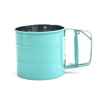 Stainless steel handheld baking flour sifter in a soft pink colour, designed for efficient sifting and aeration of dry ingredients for light and fluffy baked goods.