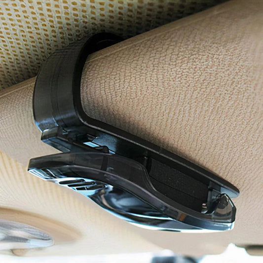 A compact plastic clip that securely holds sunglasses or glasses on a car's sun visor