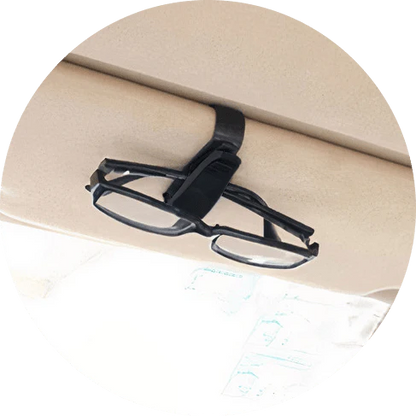 A compact plastic clip that securely holds sunglasses or glasses on a car's sun visor