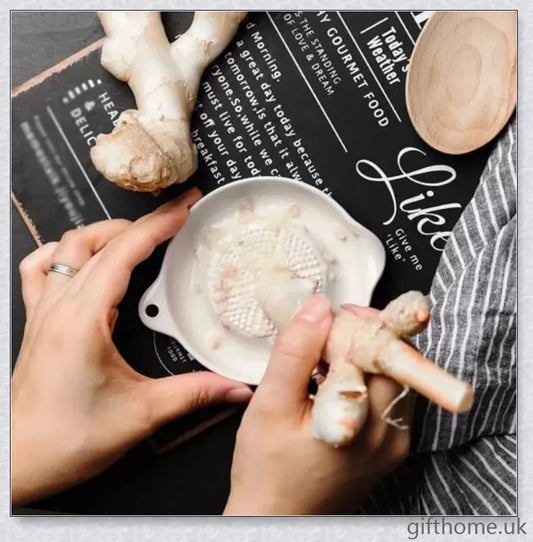 A white ceramic ginger grater, a safe and convenient kitchen tool for grating, mincing, and shredding a variety of ingredients.