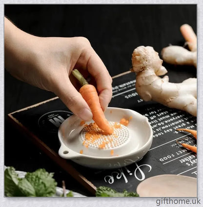 A white ceramic ginger grater, a safe and convenient kitchen tool for grating, mincing, and shredding a variety of ingredients.