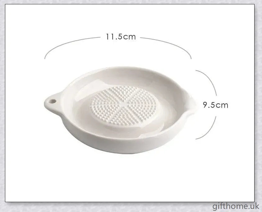 A white ceramic ginger grater, a safe and convenient kitchen tool for grating, mincing, and shredding a variety of ingredients.