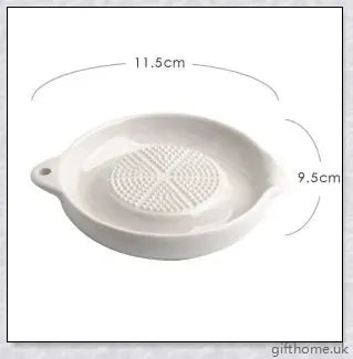 A white ceramic ginger grater, a safe and convenient kitchen tool for grating, mincing, and shredding a variety of ingredients.