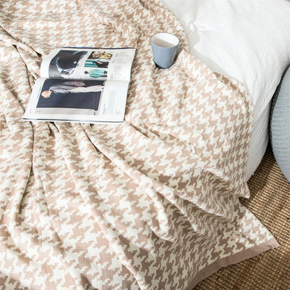 A cosy and stylish houndstooth plaid cotton blanket in various colour combinations, perfect for adding comfort and elegance to any living space.