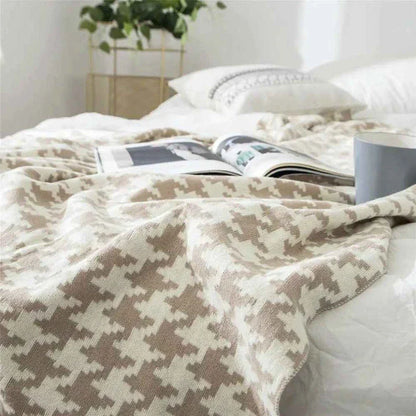 A cosy and stylish houndstooth plaid cotton blanket in various colour combinations, perfect for adding comfort and elegance to any living space.