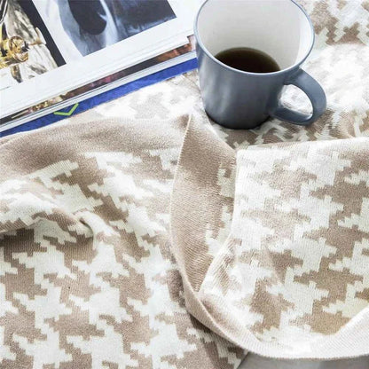 A cosy and stylish houndstooth plaid cotton blanket in various colour combinations, perfect for adding comfort and elegance to any living space.
