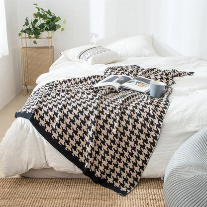 A cosy and stylish houndstooth plaid cotton blanket in various colour combinations, perfect for adding comfort and elegance to any living space.