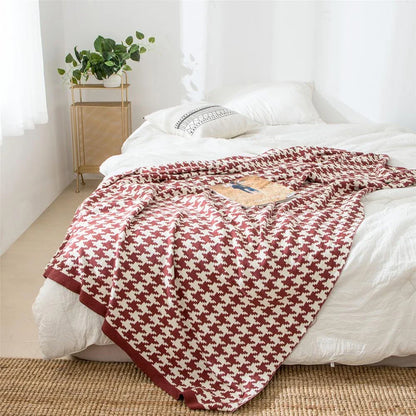 A cosy and stylish houndstooth plaid cotton blanket in various colour combinations, perfect for adding comfort and elegance to any living space.