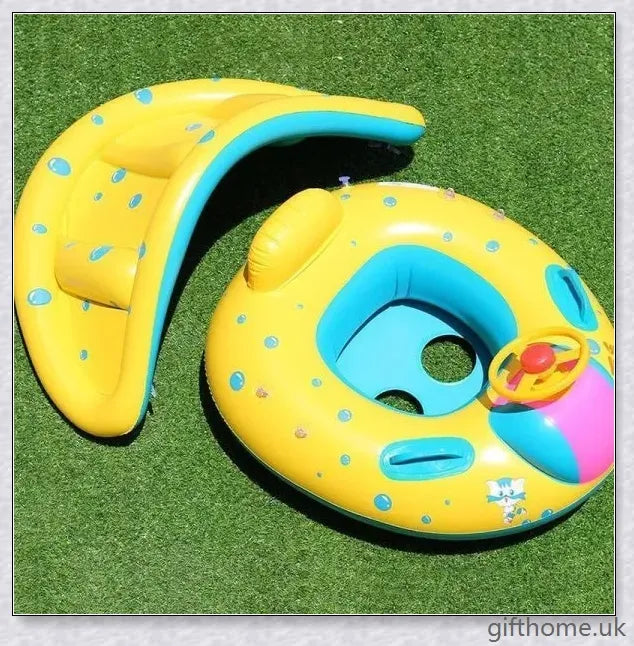 A baby swimming in a blue and white clamshell-style inflatable swimming pool float with a sun canopy and steering wheel