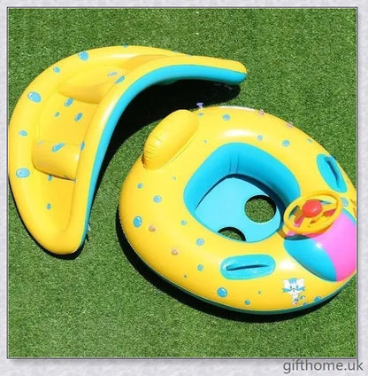 A baby swimming in a blue and white clamshell-style inflatable swimming pool float with a sun canopy and steering wheel