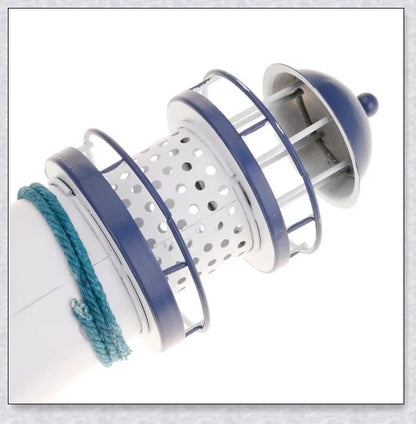 Oceanica LED Lighthouse Lantern Nightlight with nautical details like a small boat, life buoy, and seashells, providing a soft warm glow.