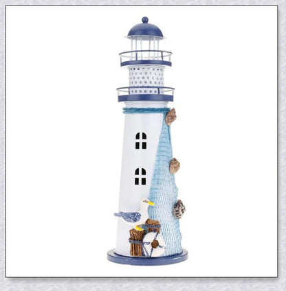 Oceanica LED Lighthouse Lantern Nightlight with nautical details like a small boat, life buoy, and seashells, providing a soft warm glow.