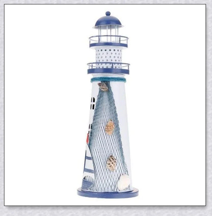 Oceanica LED Lighthouse Lantern Nightlight with nautical details like a small boat, life buoy, and seashells, providing a soft warm glow.