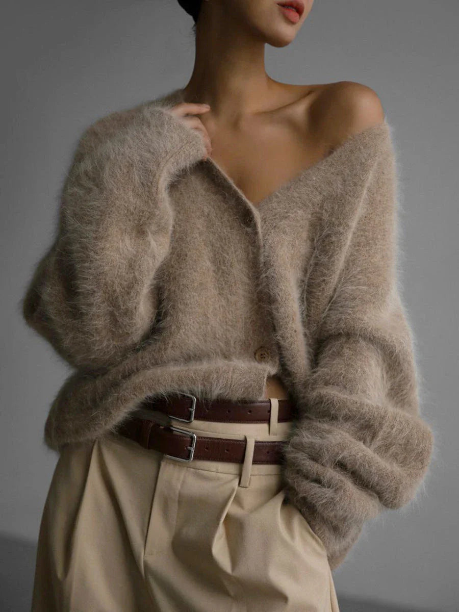 A stylish loose knit cardigan in a variety of colors, featuring a v-neck design and single-breasted closure for a flattering, relaxed fit.