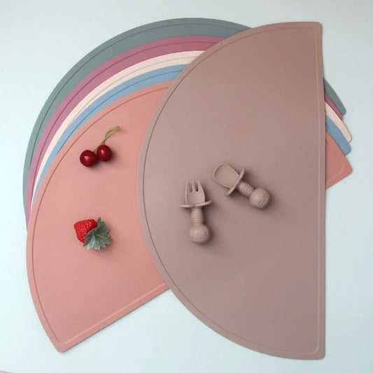 Durable silicone placemat in various colors, featuring waterproof and stain-resistant properties for easy cleaning