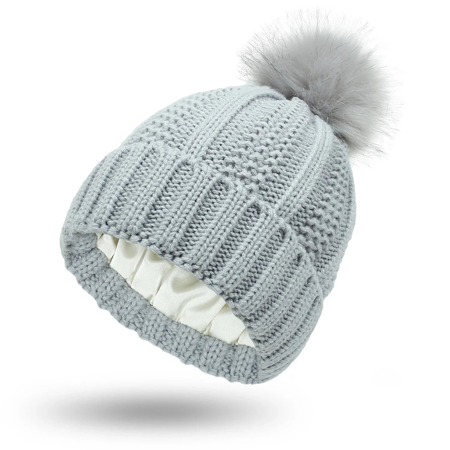 Stylish knit beanie with satin lining and faux fur pom-pom for women, available in multiple color options