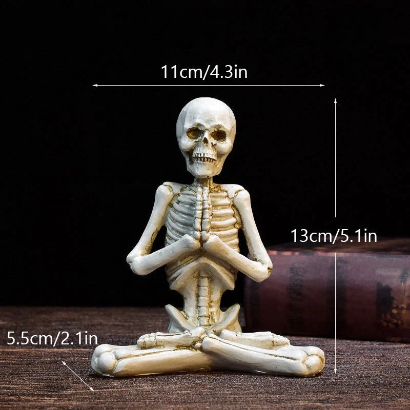 Haunting Halloween desktop ornaments, featuring intricate resin skulls and skeletons in black and vintage white finishes