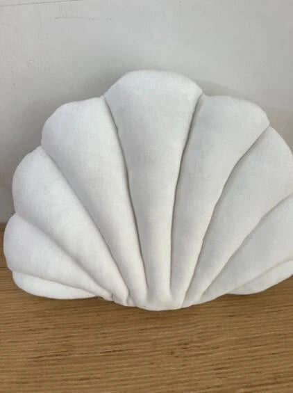 Cosy shell-shaped plush nap pillow in various colours and sizes for ultimate comfort