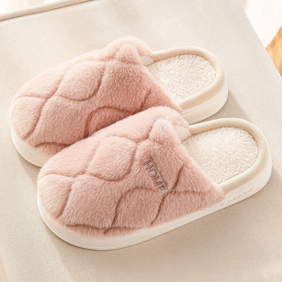 Plush slippers with soft, cushiony upper and durable PVC sole for cozy indoor comfort and traction
