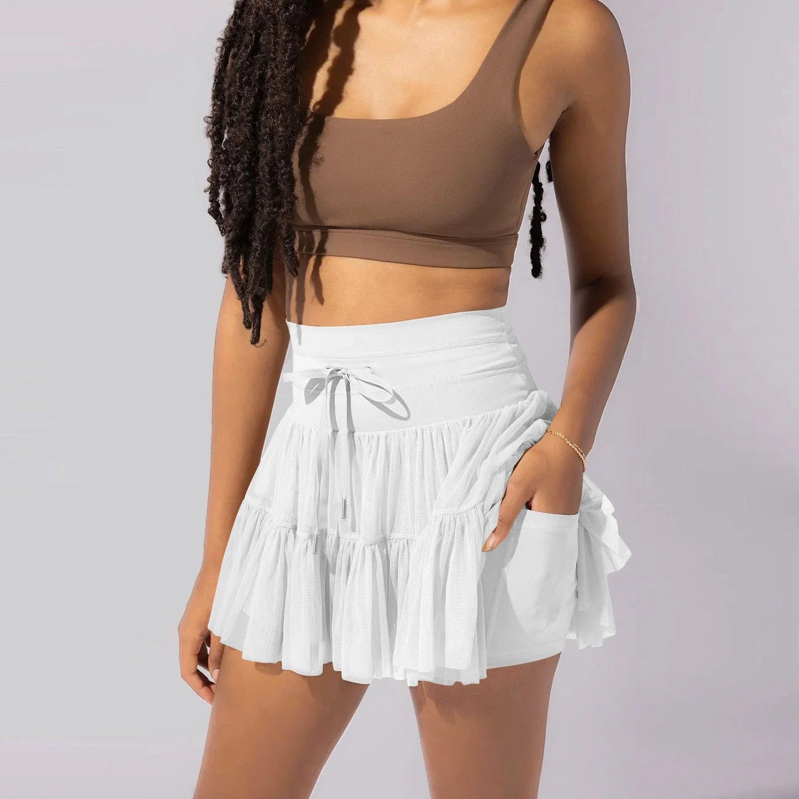 A stylish high-waist lace-up sports skirt with built-in safety shorts in a variety of vibrant colors.