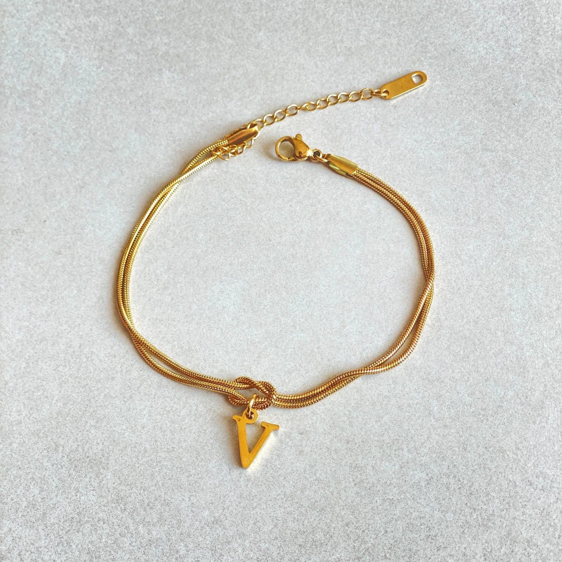 Personalised gold and silver love knot bracelets for couples, perfect as Valentine's Day gifts.