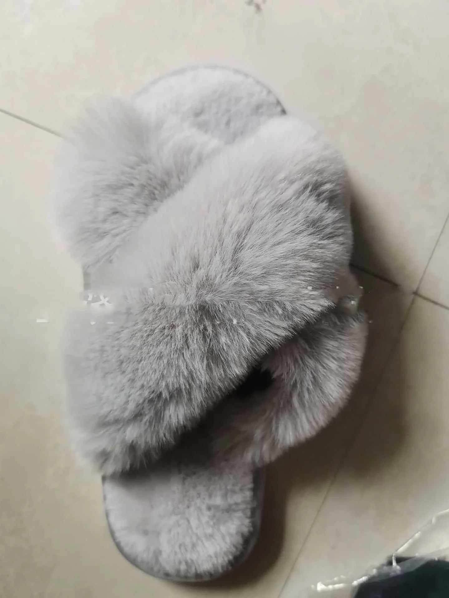Cosy faux fur slippers in a variety of classic British colours, featuring a stylish cross-over design for indoor comfort and sophistication.
