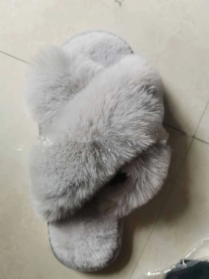 Cosy faux fur slippers in a variety of classic British colours, featuring a stylish cross-over design for indoor comfort and sophistication.