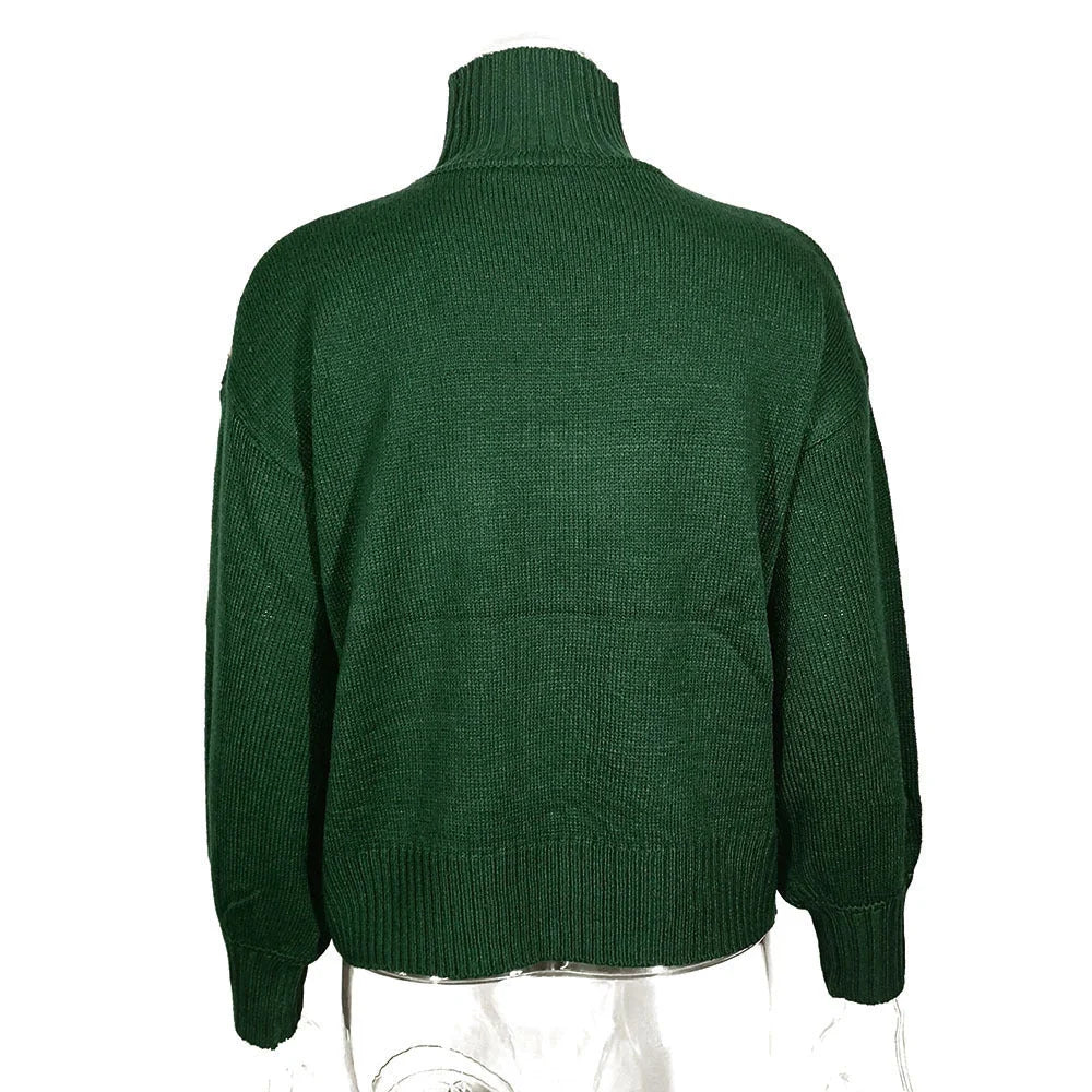 A green turtleneck sweater with a high collar, relaxed fit, and vintage-inspired design, perfect for British fashion enthusiasts.