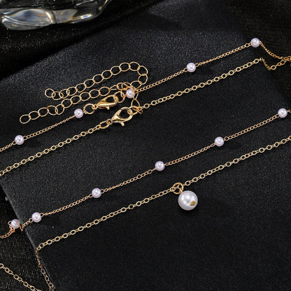 Elegant pearl and tassel double-layer necklace in gold tone, a timeless accessory for discerning women