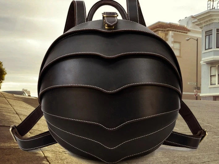 Vintage leather backpack in dark brown and black with multiple pockets