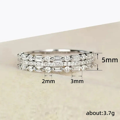 Elegant multilayer ring with a subtle geometric design, available in platinum, gold, and rose gold colours