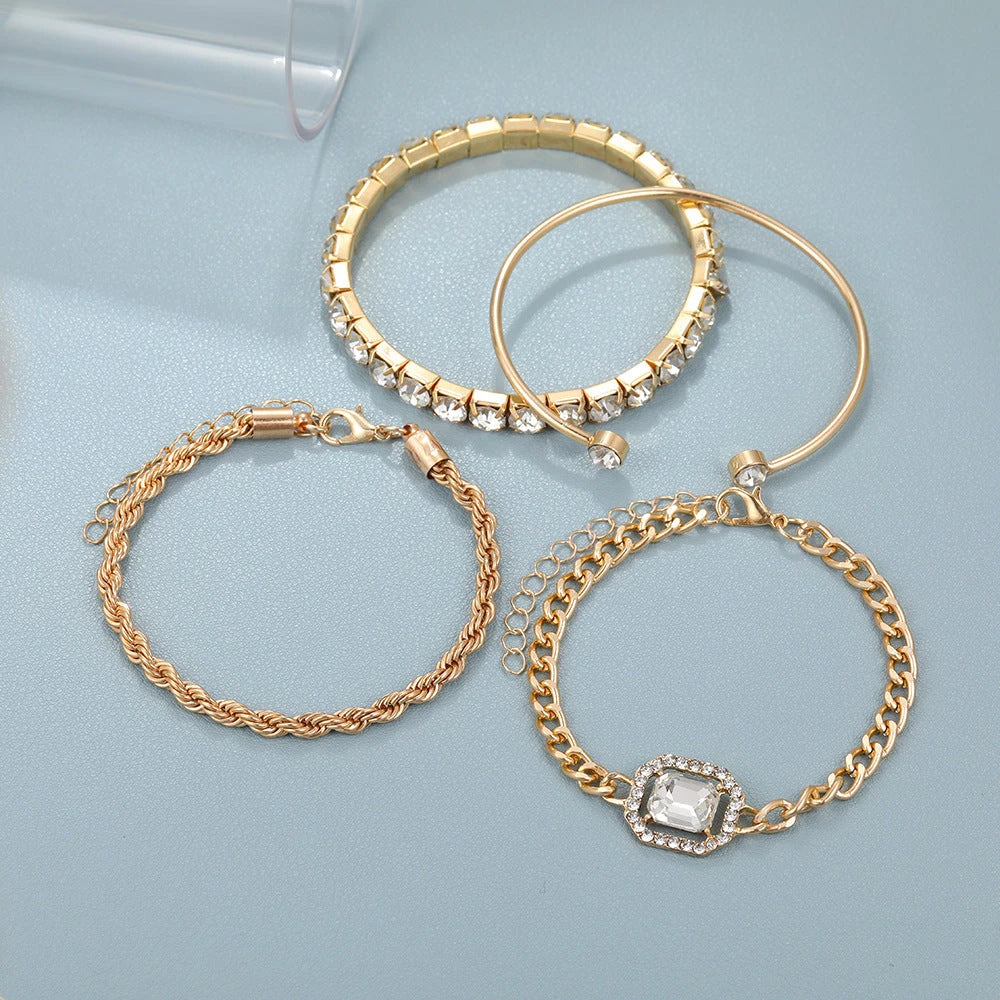 A set of four elegant crystal bracelets with vintage-inspired twisted cuff chains and sparkling rhinestones, perfect for adding a touch of luxury to any outfit.