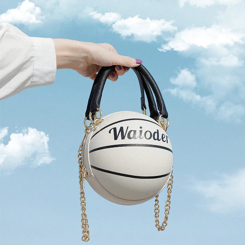 Basketball-shaped handbag in pink, white, black, or brown with adjustable chain shoulder strap