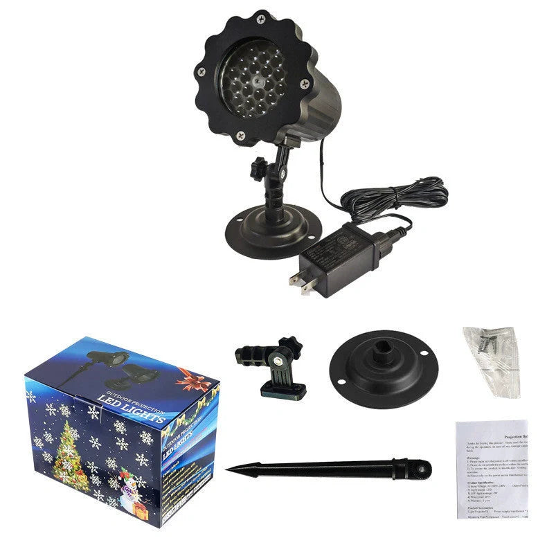 LED Christmas Blizzard Snowflake Laser Light Projector illuminating a garden with white snowflake patterns