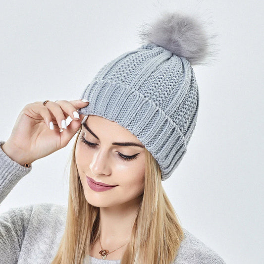 Stylish knit beanie with satin lining and faux fur pom-pom for women, available in multiple color options