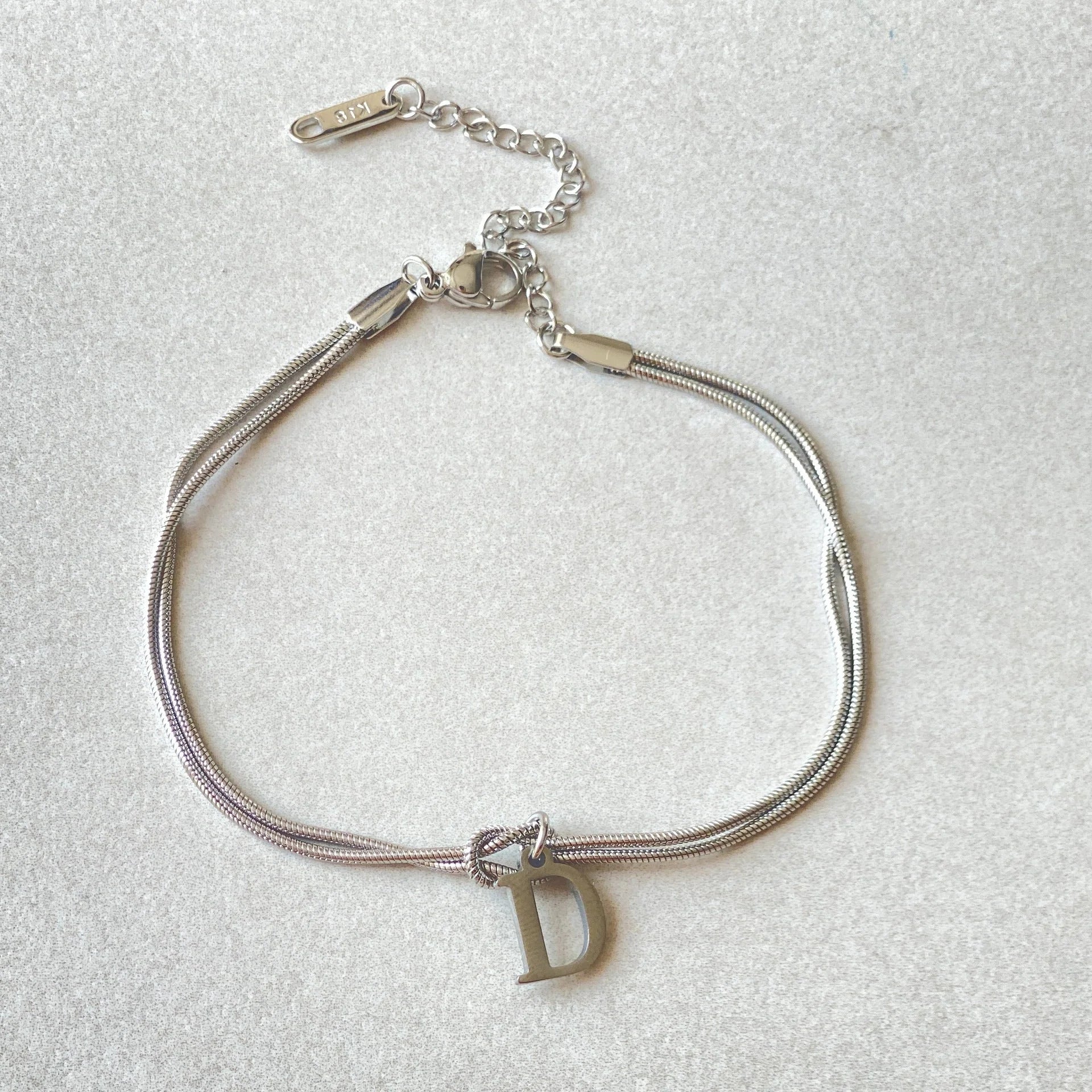 Personalised gold and silver love knot bracelets for couples, perfect as Valentine's Day gifts.