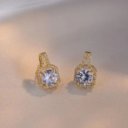 Elegant gold-toned jewelry set with zircon gemstone pendant necklace, stud earrings, and statement ring
