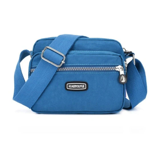 Small square messenger bag in water-repellent nylon with multi-compartment design