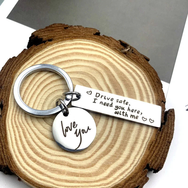 Unisex stainless steel safe driving keychain with elegant lettering