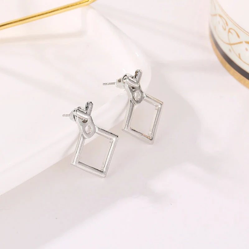 Hollow diamond square stud earrings in alloy with various finishes